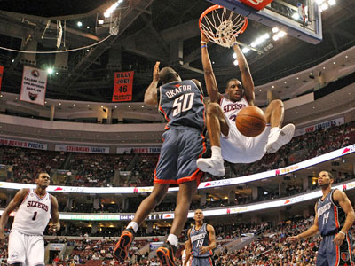 The Sixers' Thaddeus Young dunks over Charlotte's Emeka Okafor in the third quarter. (Ron Cortes / Staff Photographer) 