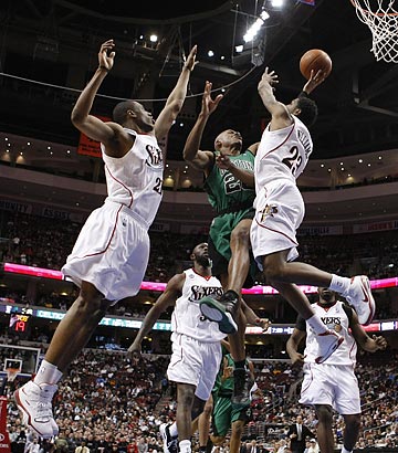 Bostn's Ray Allen tries to score on Lou Wiliams, right, and Thaddeus Young during the first half.