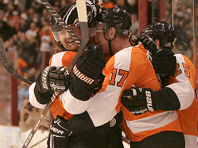 Jeff Carter celebrates with teammates after scoring a goal during the second period. (Yong Kim/Staff Photographer)