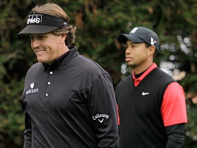 Tiger Woods watched as Phil Mickelson surged to the lead to win at Pebble Beach during the final round. (Eric Risberg/AP)