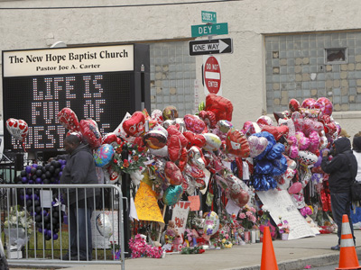 Fans created a makeshift memorial at the New Hope Baptist Church in Newark for Whitney Houston, a native of that city who died Saturday at 48. (Rich Schultz / Associated Press)