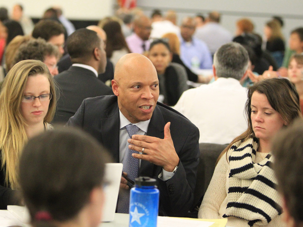 Hundreds turned out for a strategy, policy, and priorities meeting in which they were broken up into small groups on Jan. 13, 2014. Dr. William Hite, Jr, Superintendent of Schools talks to one of the groups. (CHARLES FOX/Staff Photographer)