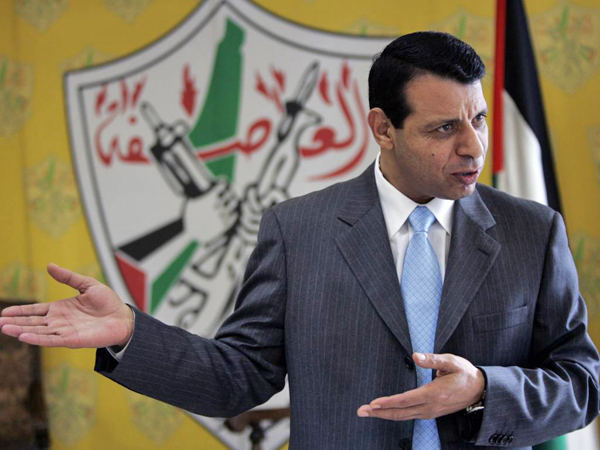 File - In this Jan. 3, 2011 file photo, Palestinian Fatah leader Mohammed Dahlan gestures as he speaks during an interview with The Associated Press in his office in the West Bank city of Ramallah. Banished in 2010 by Palestinian President Mahmoud Abbas, a former mentor, Dahlan has leveraged millions spent on needy Palestinians and his close ties with Egypt and the United Arab Emirates into growing political influence at home. (AP Photo/Majdi Mohammed, File)