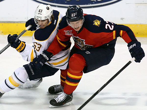 The Sabres´ Tyler Ennis (63) and Florida Panthers´ Nick Bjudstad (27) battle for the puck during the second period of an NHL hockey game in Sunrise, Fla., Friday, March 7, 2014. (J Pat Carter/AP)