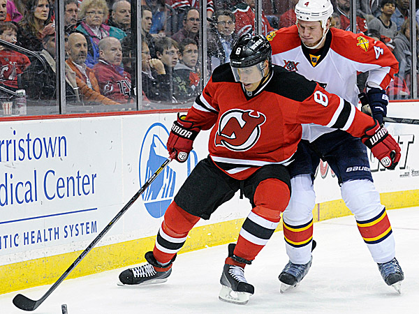 The Devils´ Dainius Zubrus holds off the Panthers´ Dylan Olsen. (Bill Kostroun/AP)