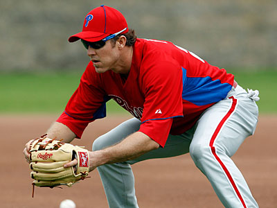 Philadelphia Phillies runner Chase Utley (L) questions his being held at  third base on a ground rule double with home plate umpire Laz Diaz during  the first inning at Coors Field in