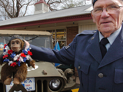 Leon Hendrick of Ridley Twp. brought his decorated monkey Chippo to stand tall on his 1945 Jeep.  (Sharon Gekoski-Kimmel/Inquirer)