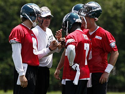 The Eagles quarterbacks talk with quarterback coach Doug Pederson during a practice on Thursday. (Alex Brandon/AP)