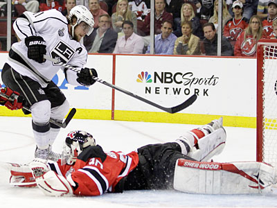 The Kings&acute; Anze Kopitar shoots the puck past Devils goalie Martin Brodeur for the winning goal in overtime. (Julio Cortez/AP Photo)