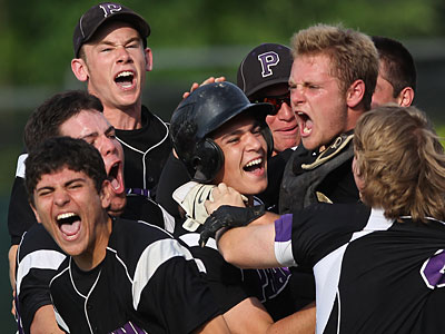 Phoenixville&acute;s Tom Kawchak, center, is mobbed by teammates after hitting the game-winning run in the seventh inning. (Michael Bryant/Staff Photographer)