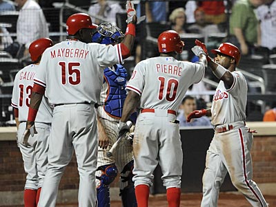Jimmy Rollins is greeted at home after his three-run home run against the Mets on Wednesday. (Kathy Kmonicek/AP) 