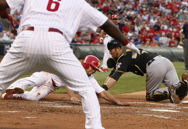 After a single by Chases Utley, Shane Victorino scores from first as Ryan Howard signals him safe as Pirates catcher Ryan Doumit misses on the tag. Philadelphia Phillies vs Pittsburgh Pirates at Citizens Bank Park on Friday, July 10, 2009. (Ron Cortes/Staff Photographer)