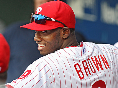 Domonic Brown was all smiles in the dugout before the start of Wednesday&acute;s game. (David M Warren/Staff Photographer)