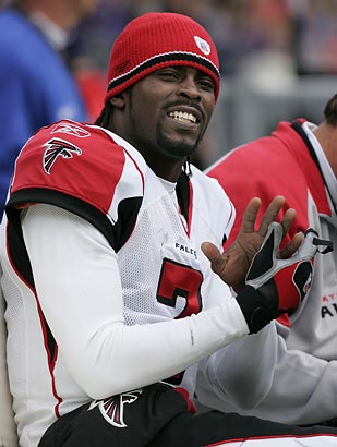 Former Atlanta Falcons and Philadelphia Eagles quarterback Michael Vick  wears one of his special edition New Era hats on sale in the NFL Shop at  the Super Bowl Experience on Thursday, Jan.