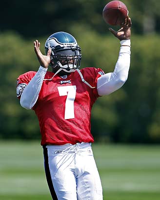 Philadelphia Eagles quarterback Michael Vick's daughter Jada Vick, 6, left,  plays with her father's helmet and her sister London Vick, 3, after an NFL  football training camp practice at Lehigh University Friday