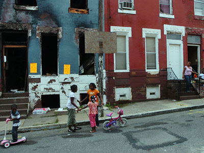 Neighborhood children play in the 1400 block of Rush Street in North Philadelphia. It was marked for demolition on Aug. 15. (Sarah J. Glover / Inquirer)