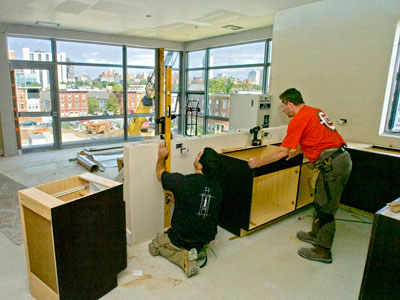 Workers install kitchen cabinets in Carl Dranoff&acute;s new apartment complex, named 777 and located at 777 South Broad St. ( Clem Murray /Staff Photographer )