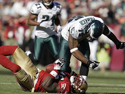 Eagles defensive end Juqua Parker crushes the 49ers´ Delanie Walker for a loss in the fourth quarter. Parker later returned an interception for a touchdown to seal the victory. (David Maialetti / Staff Photographer)