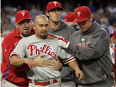 Phillies centerfielder Shane Victorino is restrained by teammates after the benches cleared in Game 3 of the NLCS against the Dodgers. (Yong Kim / Staff Photographer)