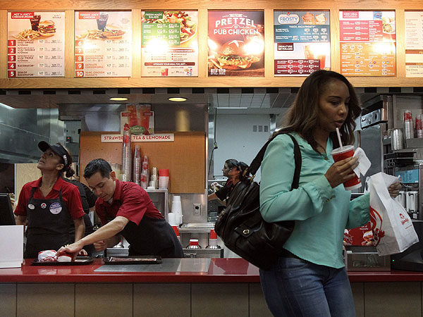 , left, and Alejandro Velasquez prepare orders for customers at Wendy ...