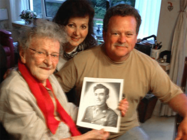 Joe and Eileen Garrity in August in the Netherlands with Jane van Haaren, holding a photo of his uncle, Pvt. Joseph Garrity. She knew him for just a few days but still felt connected to him long after.