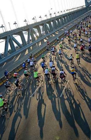 Over 4300 bikers crossed over the Ben Franklin Bridge very early Sunday morning while the sun casts long shadows on the road the bikers road to  Buena, NJ. (Michael Bryant / Inquirer)