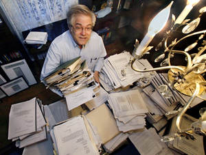 Robert B. Sklaroff sits amid the paperwork he has amassed while challenging the merger that created Highmark Inc., and now, the proposed merger of Highmark and Independence Blue Cross. The internist and oncologist estimates he has spent $100,000 since 1995 on the battle.