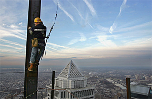 Wayne Bendistis stands on a connection lug (plate) on a 34-foot column while waiting for the crane to deliver a beam to him to connect on the 52nd floor. He is 791 feet above street level.