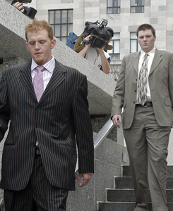 The Reid brothers - Britt (left) and Garrett - leave Montgomery County Courthouse in Norristown following a pretrial hearing yesterday. They apparently failed in their attempt to reach plea-bargain settlements and now face trials.