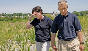 Debbie and Ed Munoz stood yesterday at the site of their former business in Juniata Park.