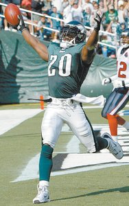 Brian Dawkins scores on a trick play , a toss from Brian Mitchell out of punt formation , in a 2002 game against the Texans.