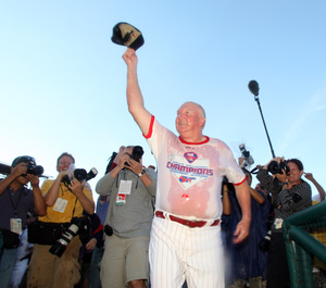 Champagne-soaked manager Charlie Manuel waves to fans after the Phillies clinched National League East.