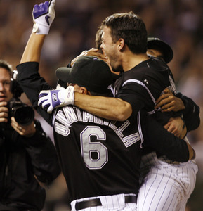 Jamey Carroll (right) joins celebration after his sacrifice fly scored winning run.