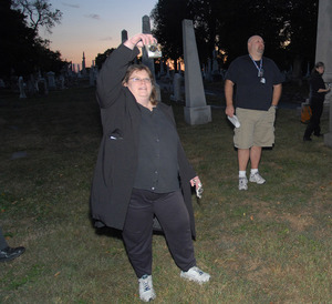 Susan Bové, looking to scare up some nightlife in Philadelphia's Laurel Hill Cemetery, points her camera in the air. The researchers say they photographed several orbs floating in the moonlight.