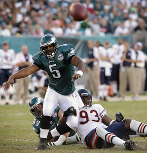Eagles QB Donovan McNabb's pass goes incomplete as Chicago's Adewale Ogunleye pulls him off balance. McNabb was 21 of 34 for 226 yards yesterday and was sacked three times.