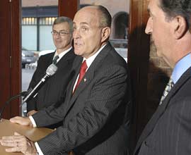 Republican presidential candidate Rudy Giuliani, center, speaks during a news conference Tuesday in Boston. He was endorsed by former Massachusetts treasurer Joseph Malone, right. Former Massachusetts Gov. Paul Celluci, left, had previously endorsed Giuliani.
