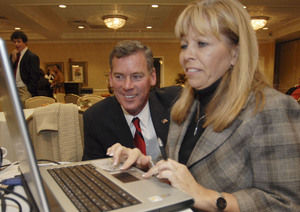 Springfield Commissioner Tom McGarrigle, who won a post on the county council, watches early returns last night with Carol Miller, vice chairman of the Delaware County GOP.