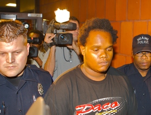 John Lewis, arrested at a Miami shelter after he was seen on TV, is taken to a cell to await extradition to Philadelphia. Asked whether he had confessed to killing Officer Chuck Cassidy, he said: "Yes."