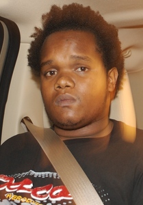 John Lewis, who identified himselfas Jordan Lewis at his extraditionhearing, is shown on his way to the Miami-Dade County jail Tuesday.