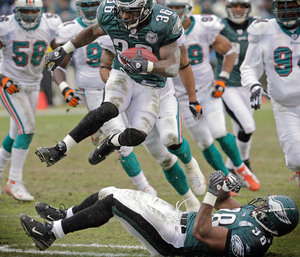 Brian Westbrook leaps over fullback Thomas Tapeh on his way to a 12-yard gain and a first down in the third quarter. Westbrook's longest run was 36 yards.
