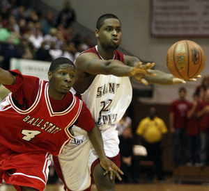 Hawks' Edwin Lashley passes around Ball State's Brandon Lampley.