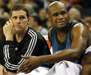 Watching their team fall behind by double digits against Golden State are Minnesota Timberwolves Mark Madsen (left) and Antoine Walker.