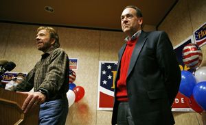 Actor Chuck Norris (left) speaking during an Iowa presidential campaign appearance by Arkansas Gov. Mike Huckabee (right).