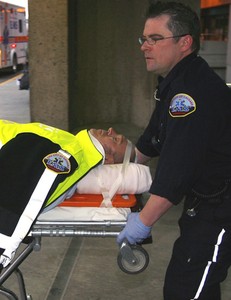 A passenger , one of 10 people injured, is transported toa hospital after a plane's emergency landing in Alberta.