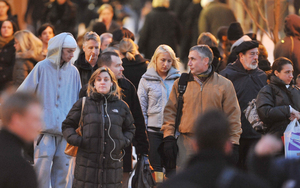 Workers heading home yesterday waited at the 16th and Market light. Of the regions surveyed on worker confidence, Philadelphians are among the most pessimistic.