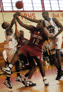 Battling for a rebound, Burlington City's Alphonso Bradford (left) and Ayo Adedjei (right) bracket Eastern's Alvin Darby (12) and Bobby Harris, who scored 16 points in the Vikings' win.