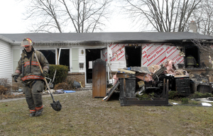 Firefighters remain on the scene of a fatal house fire on Doyle Street in Doylestown. Officials say the victim may have been smoking in bed, but the fire remains under investigation.