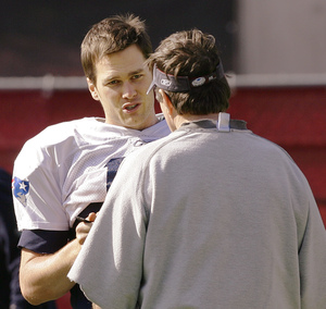 Tom Brady talks with coach Bill Belichick before practice.