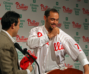 Pedro Feliz, the Phillies' new third baseman, dons a jerseyas assistant general manager Ruben Amaro Jr. watches.