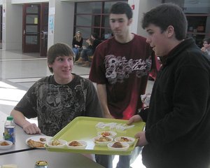 Chris Marroletti (right), a senior at Great Valley High School, hands out samples of vegetable lasagna made with locally grown produce.
